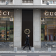 A man passes a Gucci shop in central Bucharest on February 7, 2017 in Bucharest, Romania.